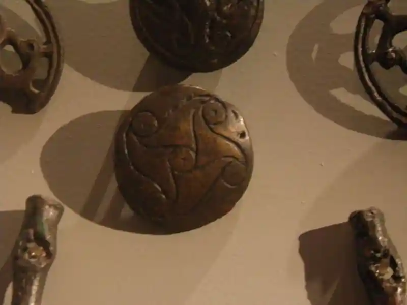 Bronze disc with rounded swastika